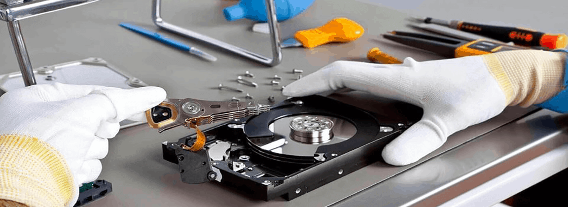 Image of specialist performing data recovery on a hard drive